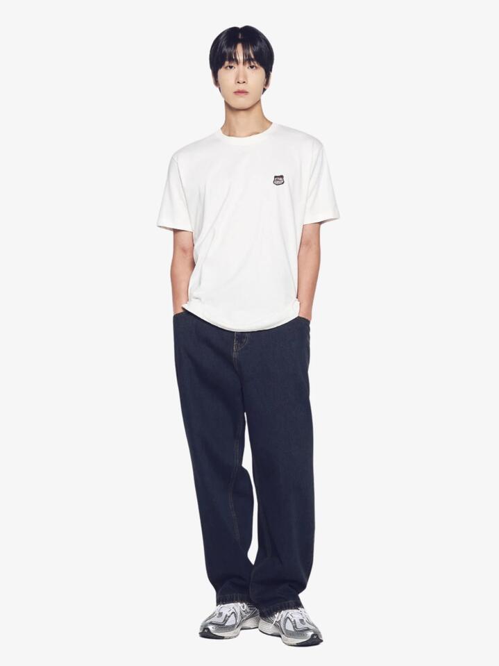 Image of a model wearing Tops. Productname: ADLV Ac Bear Wappen T-Shirt in Cream colour by brand - ADLV