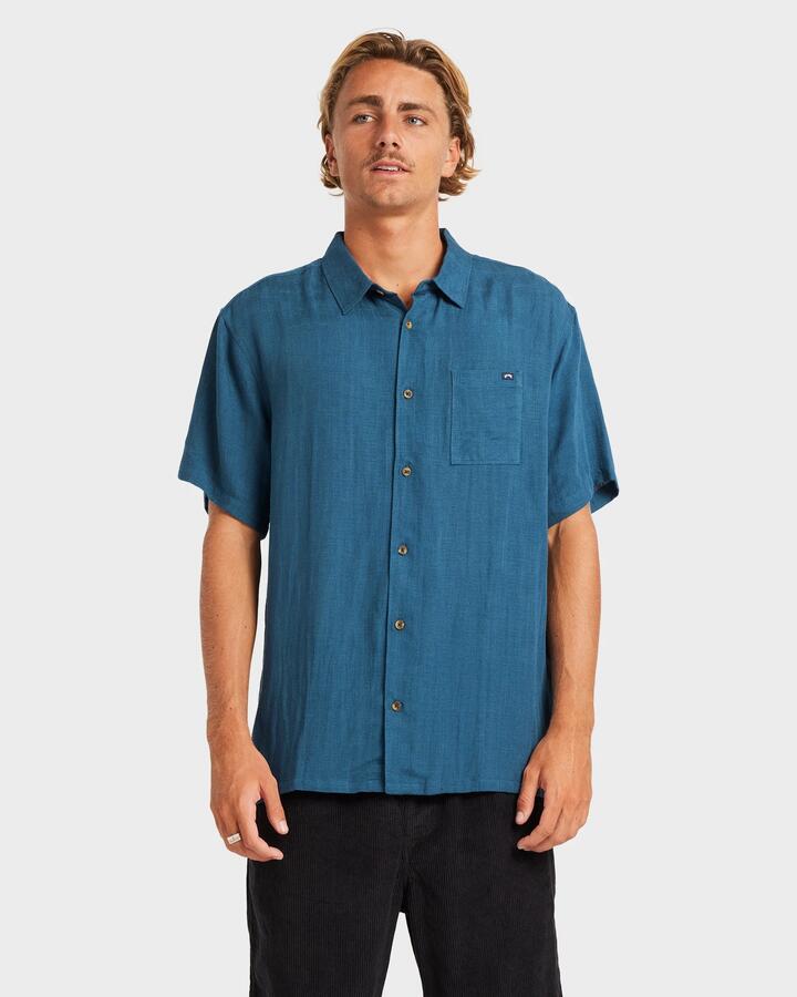 Image of a model wearing Tops. Productname: Billabong - Mens Ricardo Short Sleeve Shirt - Real Teal - in Real Teal colour by brand - Billabong