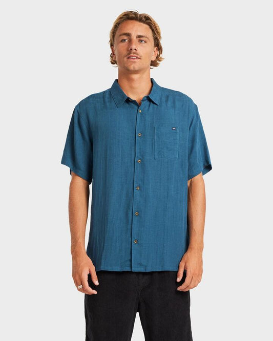 Image of a model wearing Tops. Productname: Billabong - Mens Ricardo Short Sleeve Shirt - Real Teal - in Real Teal colour by brand - Billabong