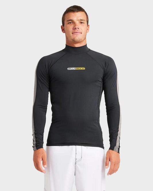 Image of a model wearing Tops. Product name - Billabong Mens Spec 73 Long Sleeve Rash Vest Black in Black colour by brand - Billabong