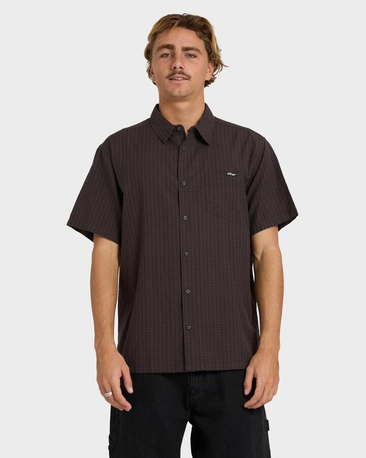 Image of a model wearing Tops. Product name - Billabong Mens Mogul Short Sleeve Shirt Raven in Raven colour by brand - Billabong