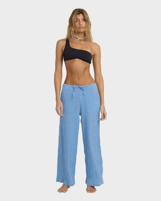 Image of a model wearing Pants. Product name - Billabong Womens Laura Elst Elastic Waist Pants Blue Drift in Blue Drift colour by brand - Billabong