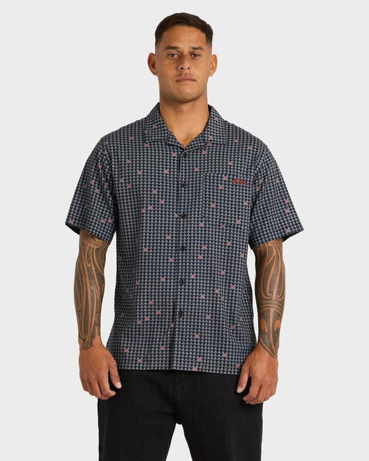 Image of a model wearing Tops. Product name - Quiksilver Mens Kehu Woven Short Sleeve Shirt Black in Black colour by brand - Quiksilver