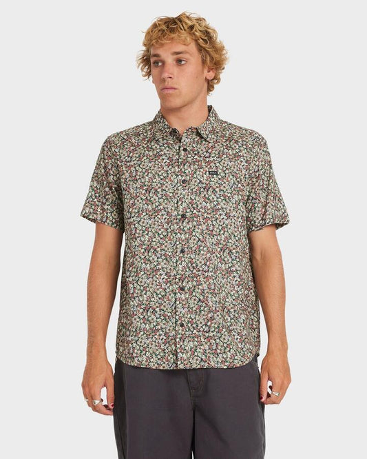 Image of a model wearing Tops. Product name - RVCA Mens Heavy Bloom Short Sleeve Shirt Black in Black colour by brand - RVCA