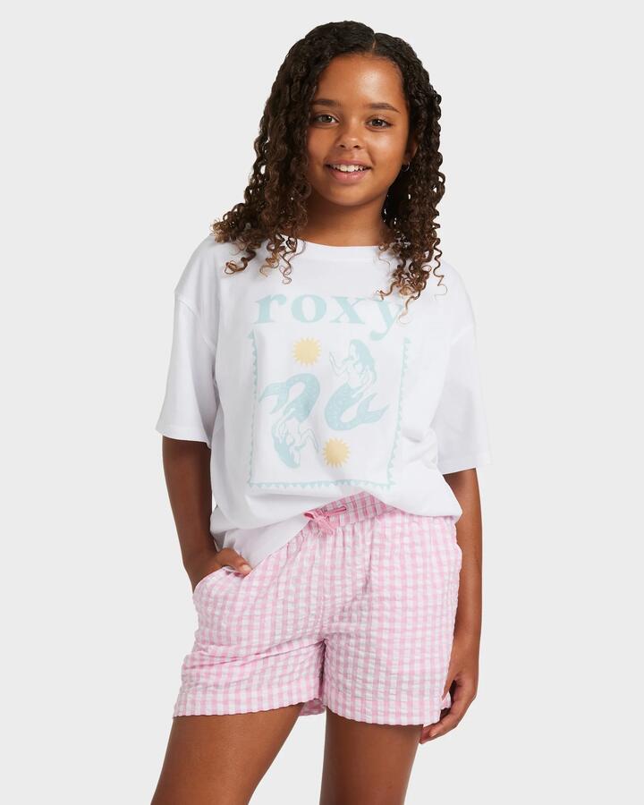 Image of a model wearing Shorts. Product name - Roxy Girls 8-16 Daisy Check Lekeito Elastic Waist Shorts Bonbon in Bonbon colour by brand - Roxy