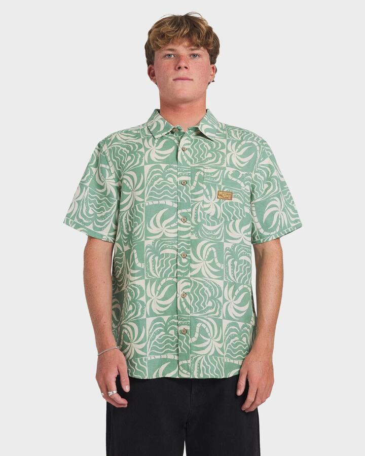 Image of a model wearing Tops. Productname: RVCA Mens Exotica Short Sleeve Shirt Sage Leaf - in Sage Leaf colour by brand - RVCA