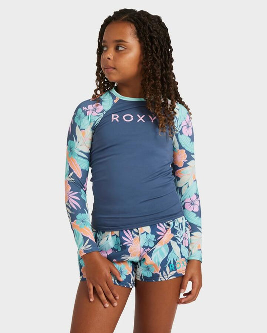 Image of a model wearing Tops. Product name - Roxy Girls 8-16 Active Lycra Long Sleeve Rash Vest Vintage Indigo Tropical Advent in Vintage Indigo Tropical Advent colour by brand - Roxy