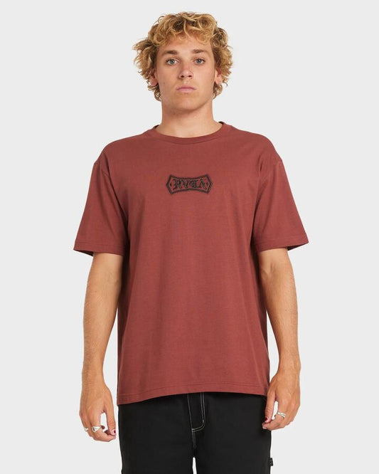 Image of a model wearing Tops. Productname: RVCA Mens Meric Text T-Shirt Red Earth - in Red Earth colour by brand - RVCA
