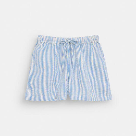Image of a model wearing Shorts. Productname: Striped Seersucker Shorts in BLUE MULTI colour by brand - Coach Outlet Australia