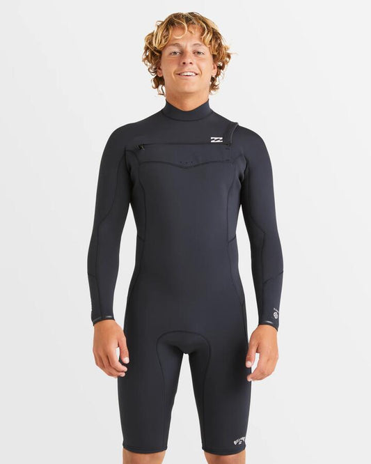 Image of a model wearing Tops. Product name - Billabong Mens 2/2Mm Absolute Natural Chest Zip Long Sleeve Springsuit Black in Black colour by brand - Billabong