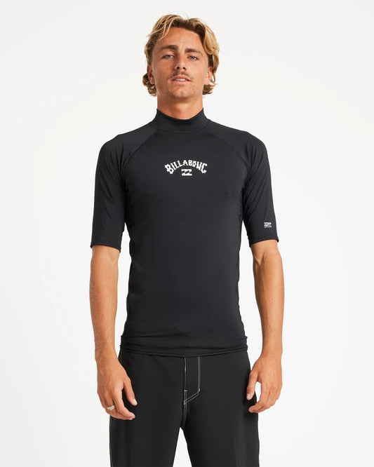 Image of a model wearing Tops. Product name - Billabong Mens All Day Arch Short Sleeve Rash Vest Black in Black colour by brand - Billabong