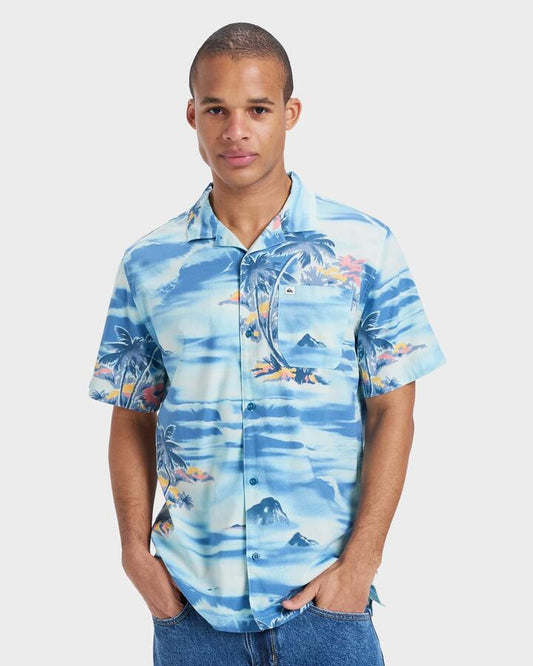 Image of a model wearing Tops. Productname: Quiksilver - Mens Beach Club Short Sleeve Shirt - Horizon Blue Tropical Surf 64 - in Horizon Blue Tropical Surf 64 colour by brand - Quiksilver