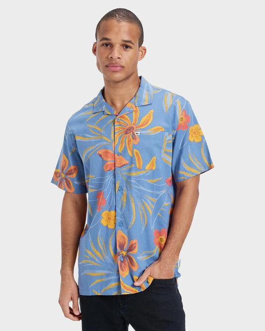 Image of a model wearing Tops. Productname: Quiksilver - Mens Beach Club Short Sleeve Shirt - Coronet Blue Surrealism 64 - in Coronet Blue Surrealism 64 colour by brand - Quiksilver