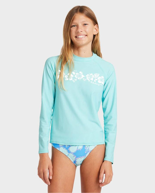 Image of a model wearing Tops. Product name - Billabong Girls 8-16 Heat Wave Long Sleeve Rash Vest Sea Mist in Sea Mist colour by brand - Billabong