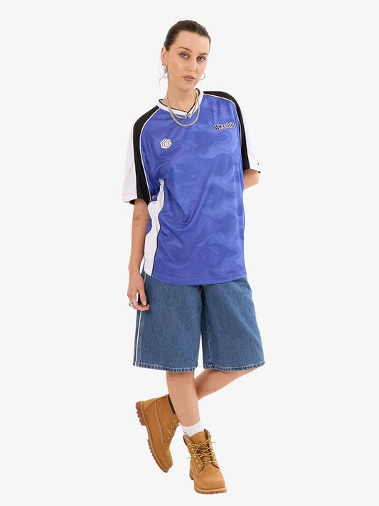 Image of a model wearing Tops. Productname: Worship Smoke V-Neck Football Jersey in COBALT colour by brand - Worship