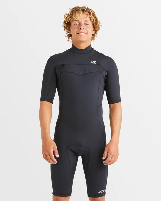 Image of a model wearing Tops. Productname: Billabong Mens 2/2Mm Absolute Natural Chest Zip Springsuit Black - in Black colour by brand - Billabong
