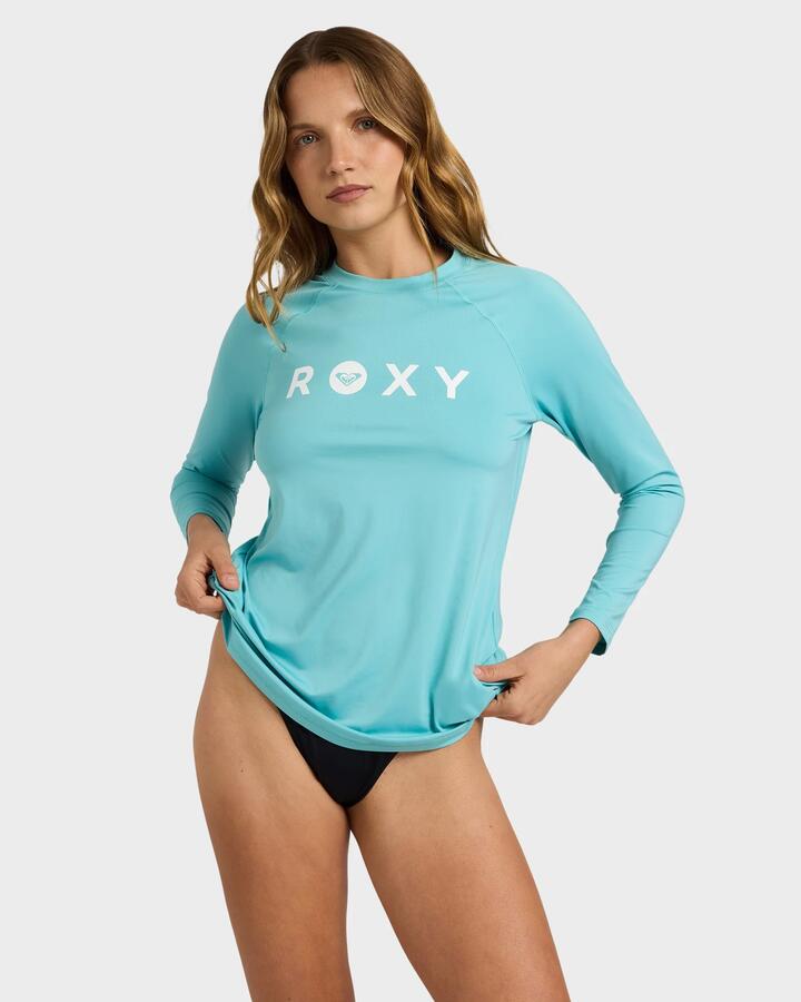 Image of a model wearing Tops. Product name - Roxy Womens Essentials Long Sleeve Rash Vest Coastal Shade in Coastal Shade colour by brand - Roxy