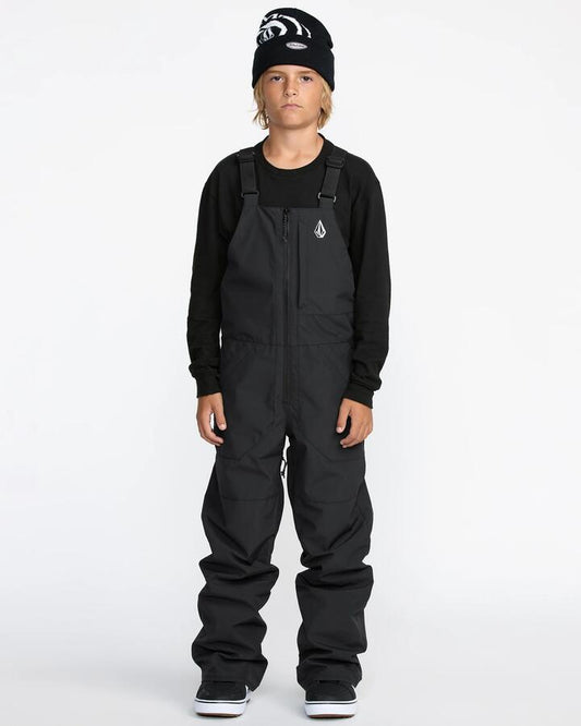 Image of a model wearing Pants. Product name - Volcom Boys 8-16 Barkley Insulated Bib Snow Pants Black in Black colour by brand - Volcom