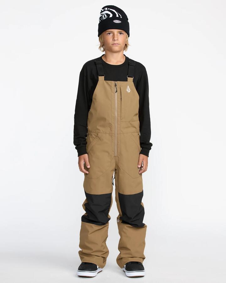 Image of a model wearing Pants. Product name - Volcom Boys 8-16 Barkley Insulated Bib Snow Pants Bronze in Bronze colour by brand - Volcom