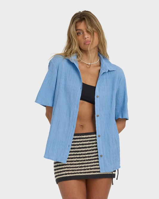 Image of a model wearing Tops. Productname: Billabong - Womens Laura Oversized Short Sleeve Shirt - Blue Drift - in Blue Drift colour by brand - Billabong