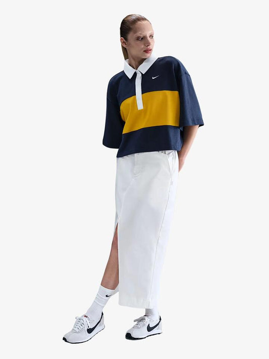 Image of a model wearing Shorts. Productname: Nike Women's NSW Oversized Short-Sleeve Polo Top in Mdnt Nvy/Drk Slfr/Wht/Wht colour by brand - Nike
