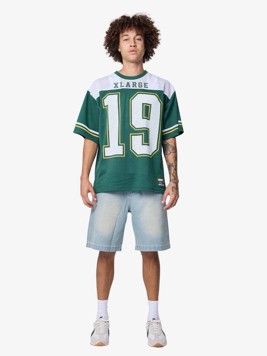 Image of a model wearing Tops. Productname: Xlarge Star Game Shirt in Packers Green colour by brand - Xlarge