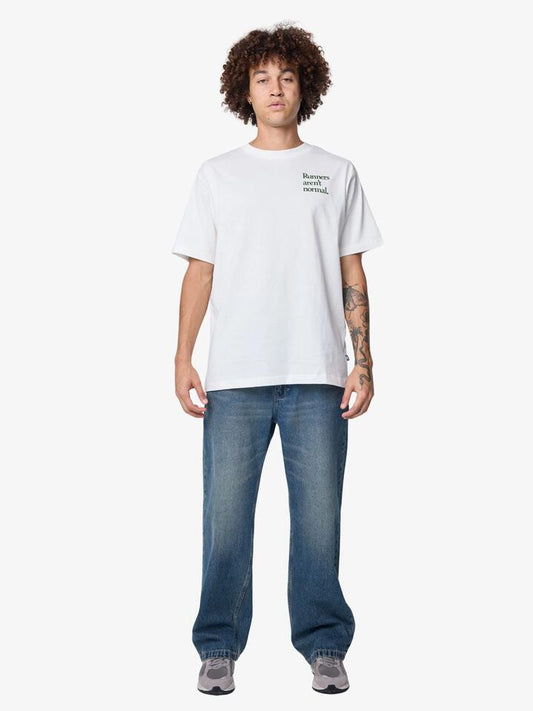 Image of a model wearing Tops. Productname: New Balance Runners Arent Normal T-Shirt - Sea Salt in Sea Salt colour by brand - New Balance