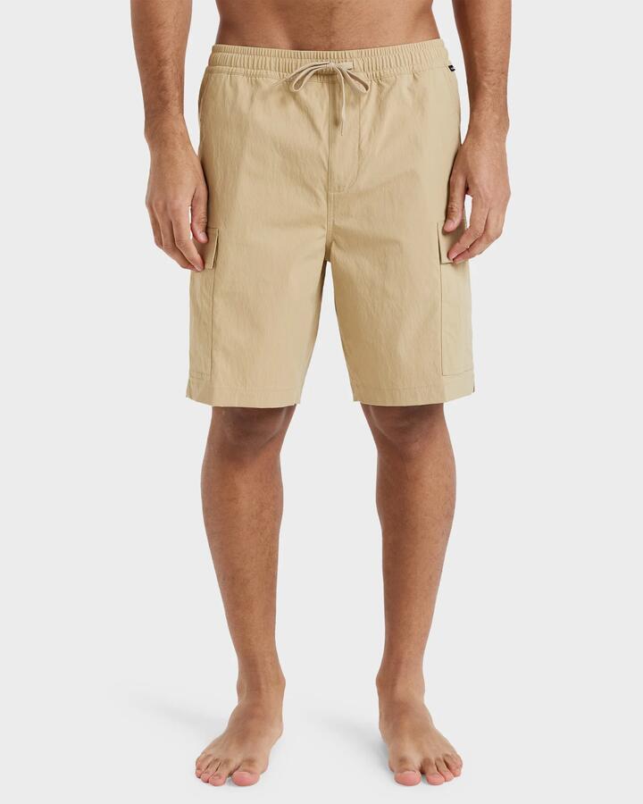 Image of a model wearing Shorts. Product name - Quiksilver Mens Taxer Cargo 19" Hybrid Shorts Khaki in Khaki colour by brand - Quiksilver