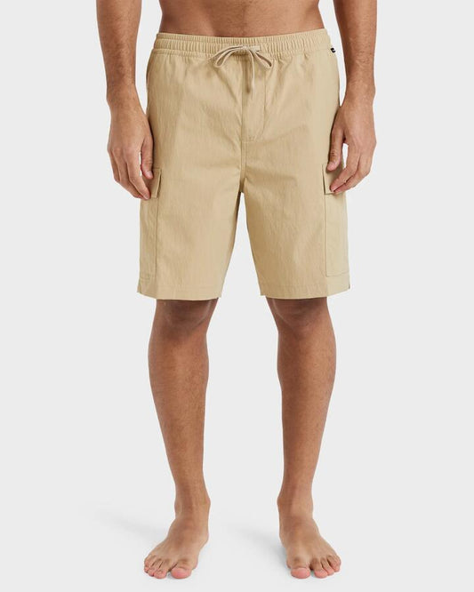 Image of a model wearing Shorts. Product name - Quiksilver Mens Taxer Cargo 19" Hybrid Shorts Khaki in Khaki colour by brand - Quiksilver