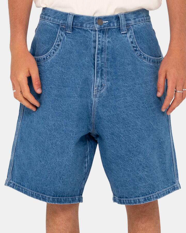 Image of a model wearing Shorts. Productname: rusty - Mens Flip Daddy Tapeless Denim Shorts - Middy Blue - in Middy Blue colour by brand - rusty