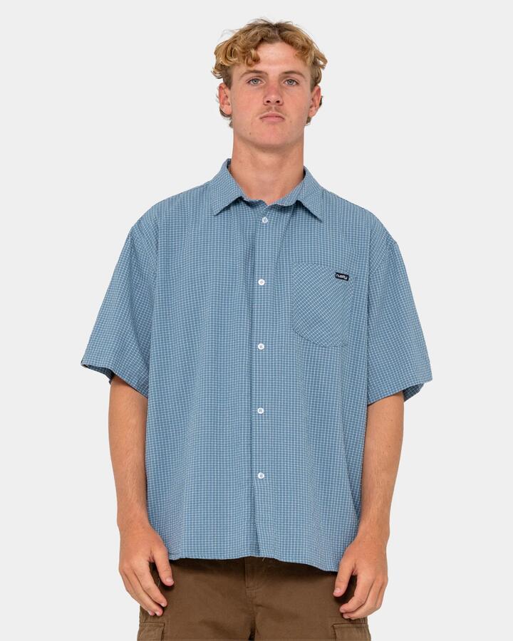Image of a model wearing Tops. Product name - Rusty Mens Acemo Check Short Sleeve Shirt China Blue in China Blue colour by brand - Rusty