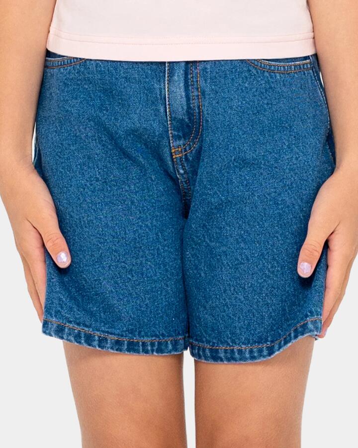 Image of a model wearing Shorts. Product name - Rusty Girls 8-14 Cyprus High Denim Shorts Mid Blue in Mid Blue colour by brand - Rusty