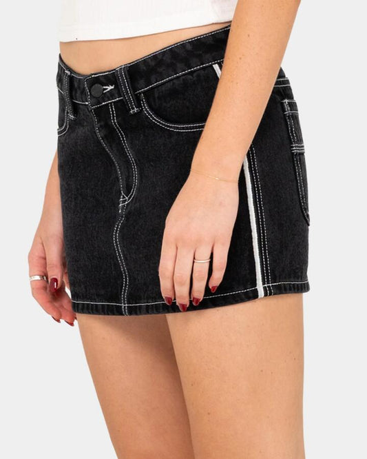 Image of a model wearing Skirts. Product name - Rusty Womens Flip Mommy Low Rise Denim Skirt Black in Black colour by brand - Rusty