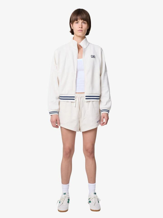 Image of a model wearing Outerwear. Productname: New Balance Reimagined Fleece Shorts in Linen colour by brand - New Balance