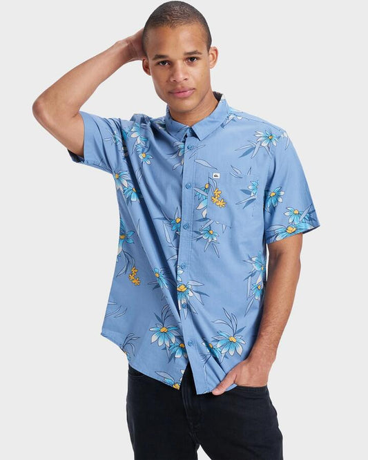 Image of a model wearing Tops. Productname: Quiksilver - Mens Apero Classic Short Sleeve Shirt - Coronet Blue Costal Flora 64 - in Coronet Blue Costal Flora 64 colour by brand - Quiksilver