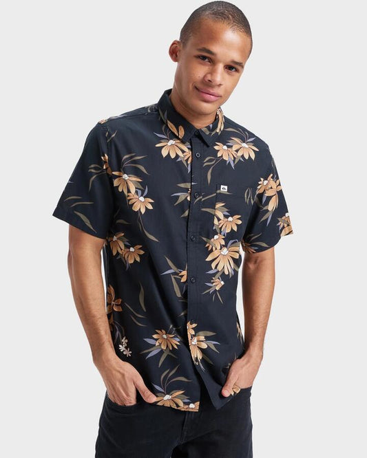 Image of a model wearing Tops. Productname: Quiksilver - Mens Apero Classic Short Sleeve Shirt - Black Costal Flora 64 - in Black Costal Flora 64 colour by brand - Quiksilver