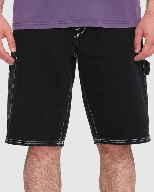 Image of a model wearing Shorts. Productname: Volcom - Mens Labored Denim Utility Denim Short - Black - in Black colour by brand - Volcom