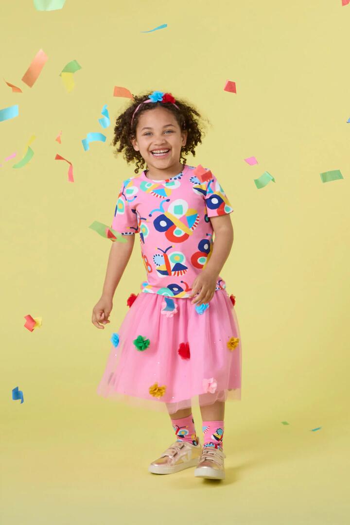 Image of a model wearing Skirts. Product name - Pom Pom Mesh Kids Skirt in Pink colour by brand - Gorman
