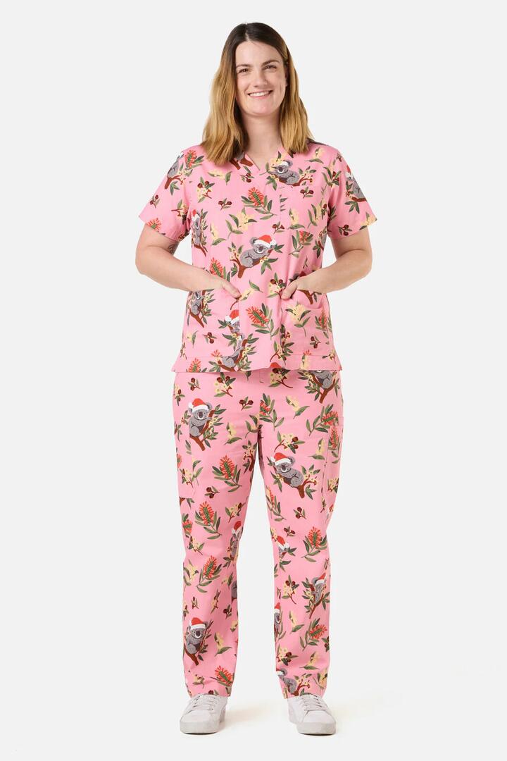 Image of a model wearing Uniforms & Workwear. Productname: Christmas Koala Pink Scrub Set in Pink colour by brand - Scrubs With Love
