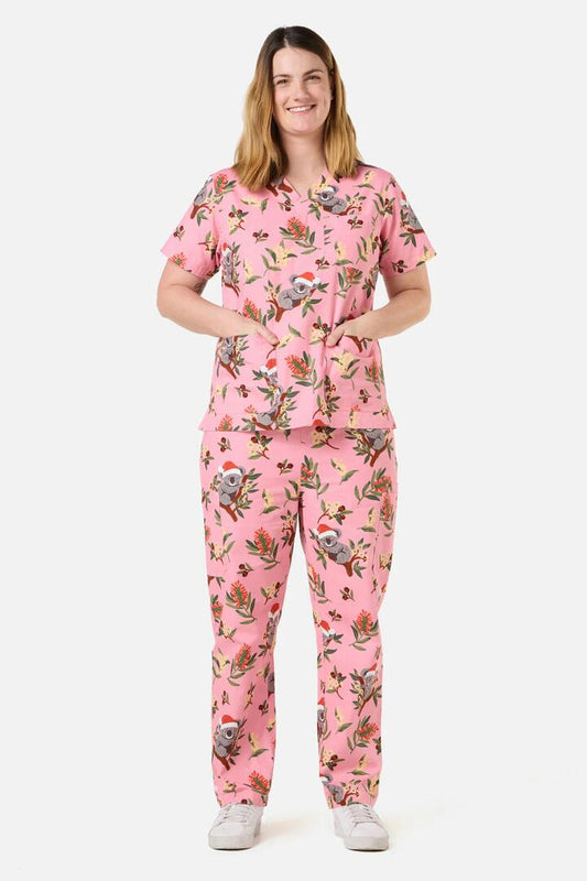Image of a model wearing Uniforms & Workwear. Productname: Christmas Koala Pink Scrub Set in Pink colour by brand - Scrubs With Love