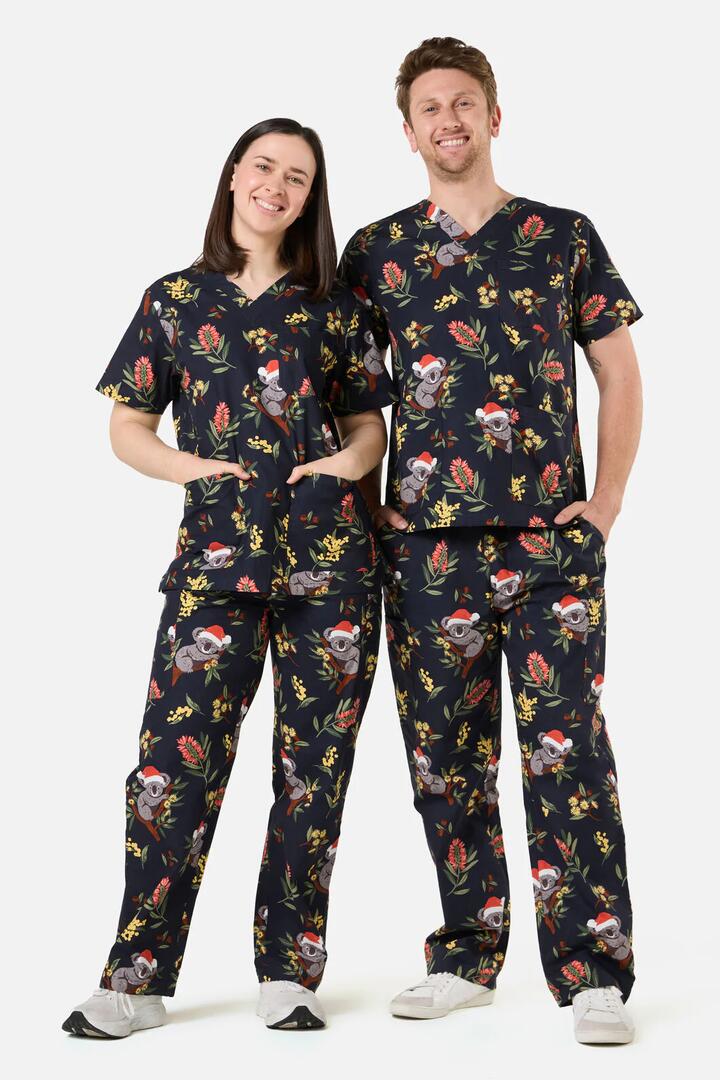 Image of a model wearing Uniforms & Workwear. Productname: Christmas Koala Navy Scrub Set in Navy colour by brand - Scrubs With Love