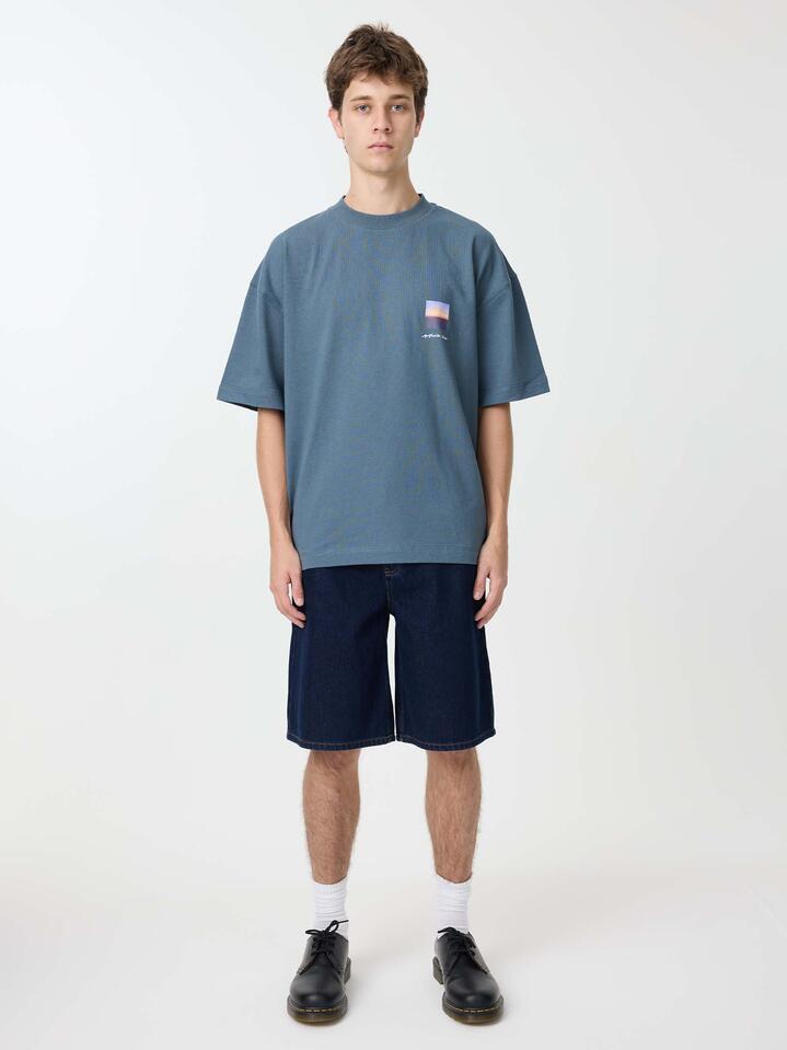 Image of a model wearing Tops. Productname: Article One Peaceful Sky Tee in Steel Blue colour by brand - Article One