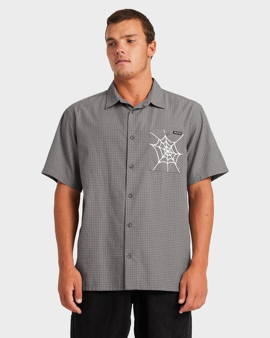 Image of a model wearing Tops. Product name - Billabong Mens Web Mogul Short Sleeve Shirt Raven in Raven colour by brand - Billabong