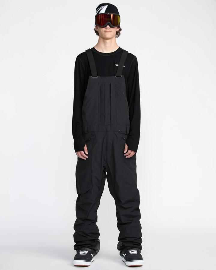 Image of a model wearing Pants. Product name - Volcom Mens Rain Gore-Tex Bib Snow Pants Black in Black colour by brand - Volcom