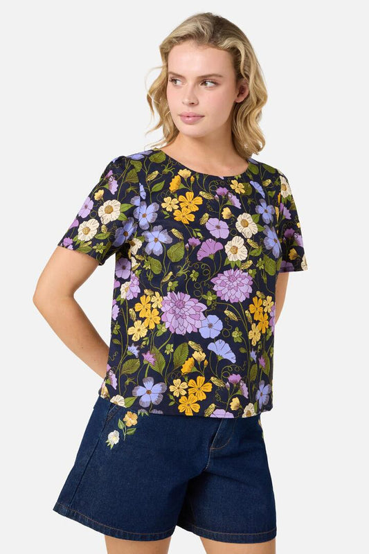 Image of a model wearing Tops. Productname: Grasshopper Floral SS Top in Navy colour by brand - Princess Highway