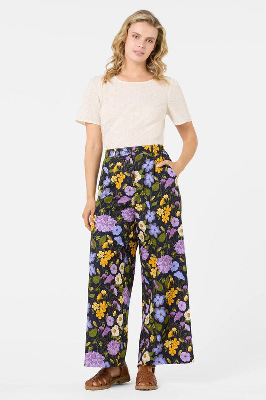 Image of a model wearing Pants. Productname: Grasshopper Floral Pant in Navy colour by brand - Princess Highway