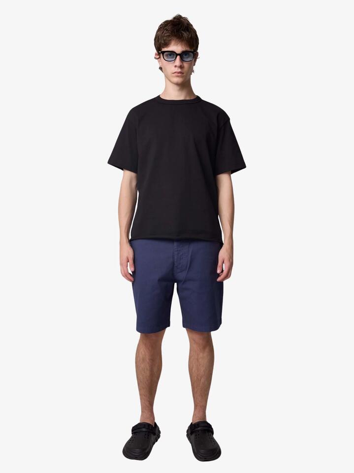 Image of a model wearing Shorts. Productname: Deus Big Fella Overdye Shorts in Indigo colour by brand - Deus