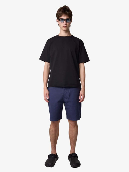 Image of a model wearing Shorts. Productname: Deus Big Fella Overdye Shorts in Indigo colour by brand - Deus