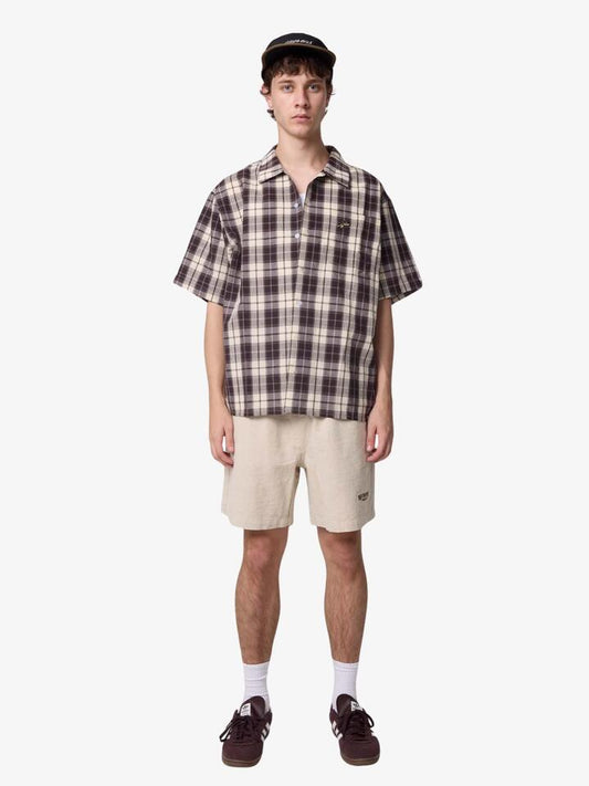 Image of a model wearing Shorts. Productname: Worship Satisfaction Baggy Cotton Linen Shorts in Oatmeal colour by brand - Worship