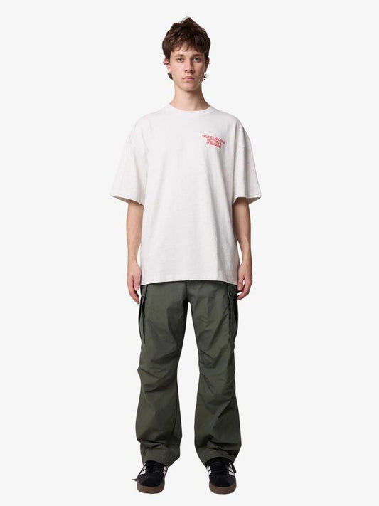 Image of a model wearing Tops. Productname: Deus You Are Welcome Tee in Lt Grey Marle colour by brand - Deus